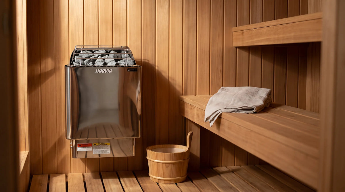 Harvia KIP60W 6 kW electric sauna heater wall mounted in a compact cedar sauna