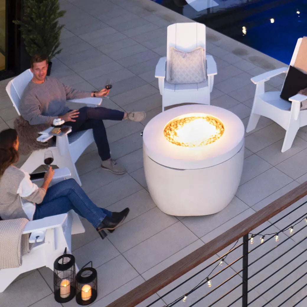 Four Adirondack chairs around the Halo fire pit