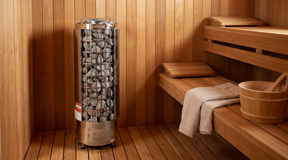 Harvia Cilindro PC60E 6 kW electric sauna heater standing on the cedar floor of a sauna