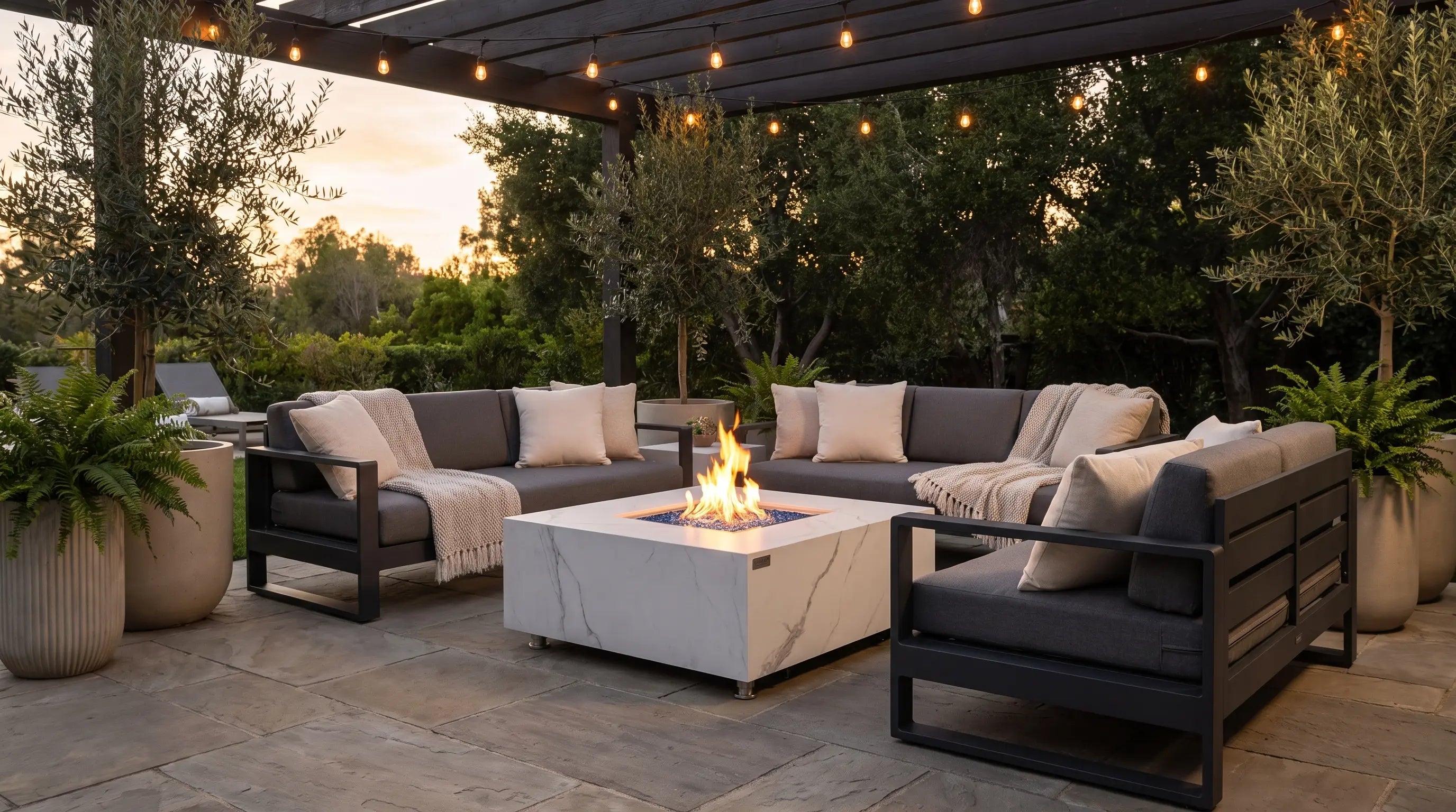 Elementi Bianco marble porcelain square gas fire table on a modern patio at dusk