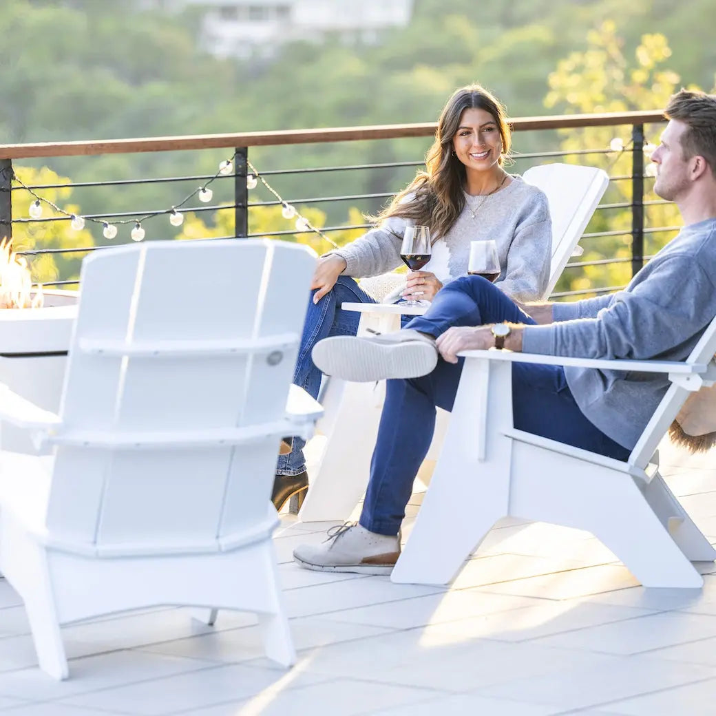 Fire pit with Adirondack chairs on a backyard patio