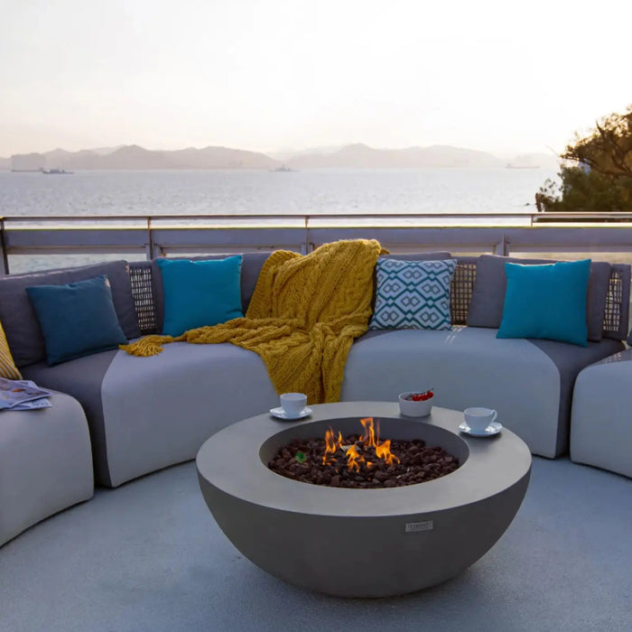 Lunar fire bowl in a lifestyle outdoor setting — modern decorative gas fire bowl perfect for evening patio gatherings