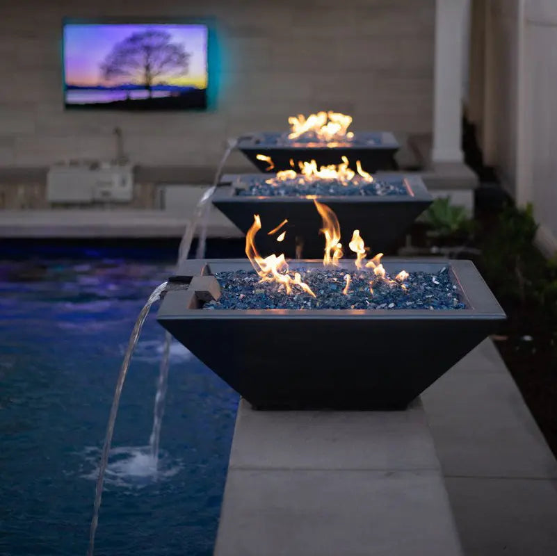 The Outdoor Plus Maya 36 inch Square Concrete Fire and Water Bowl beside a pool