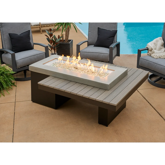 Uptown linear gas fire pit dining table in lifestyle outdoor setting — rectangular outdoor dining table with built-in linear fire feature for entertaining